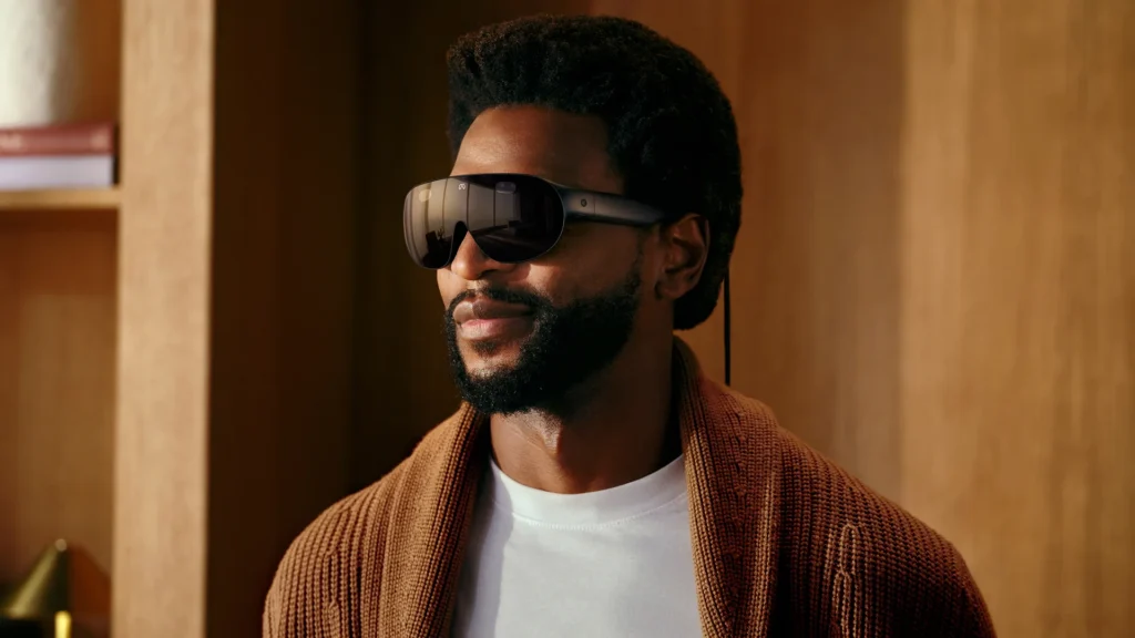 Man wearing Meta VR Glasses, a lightweight glasses-style VR headset, in a wood-panelled room